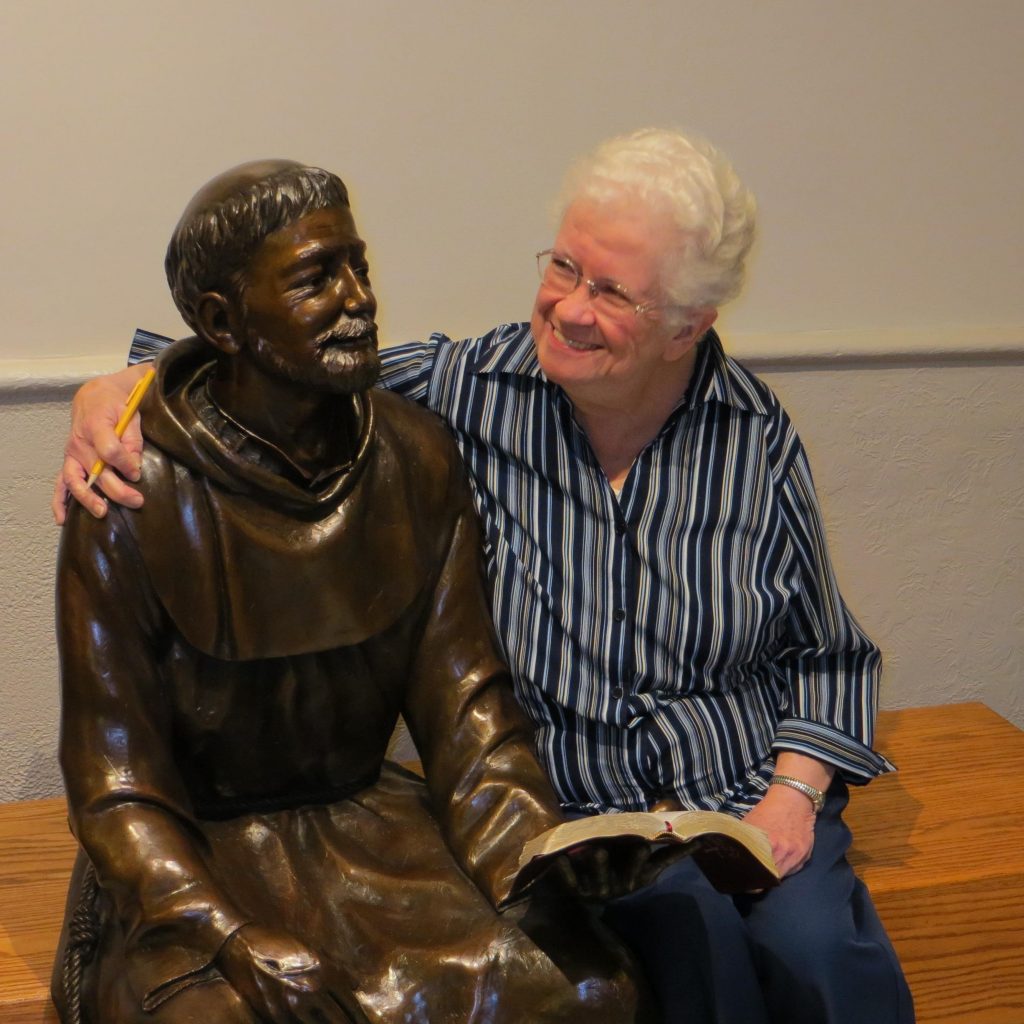 Sister Ann Marie Slavin with a statue of St. Francis